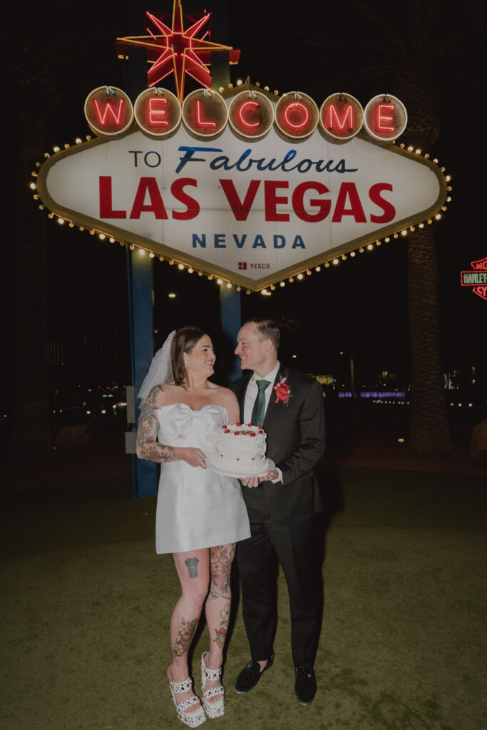 couple at las vegas sign